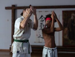 a boy training in the gym with his trainer